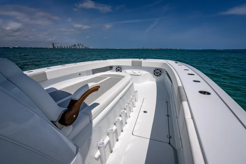 Slide: The Image of 2025 Freeman 43 boat on open water with city skyline in background. - 56