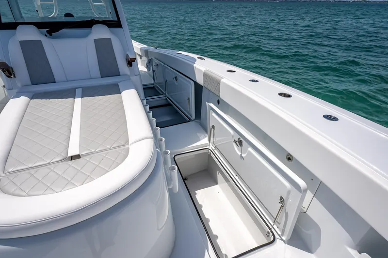 Slide: The Image of Luxurious 2025 Freeman 43 boat interior with cushioned seating and storage, on open water. - 69