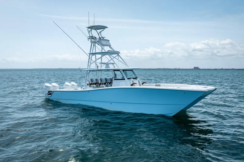 Slide: The Image of 2025 Freeman 43 boat on open water, featuring sleek design and multiple outboard engines. - 7