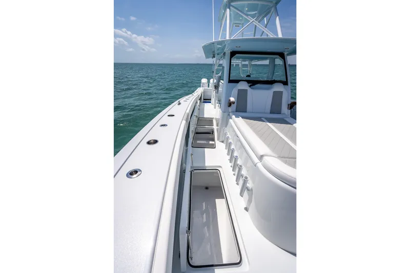 Slide: The Image of 2025 Freeman 43 boat deck with seating and storage, cruising on open water. - 71
