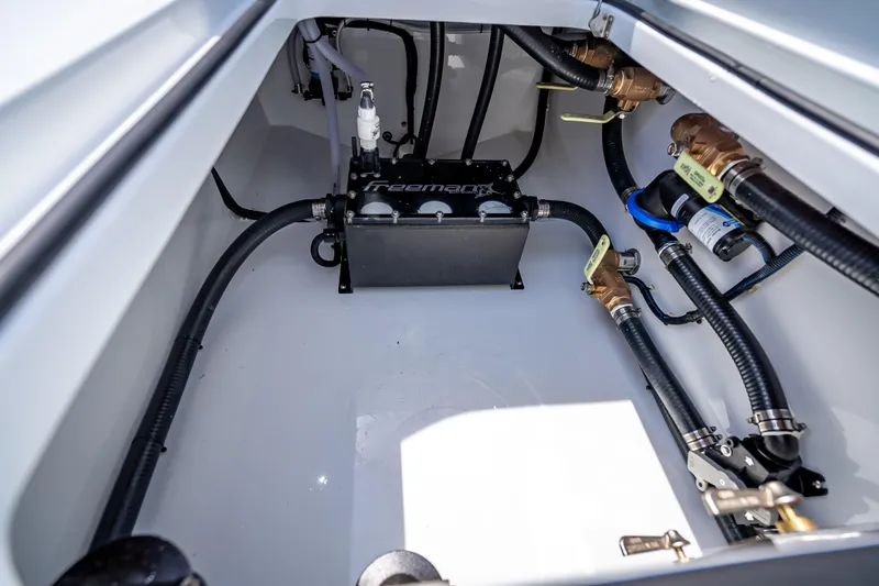 Slide: The Image of 2025 Freeman 43 boat engine compartment with hoses and mechanical components. - 72