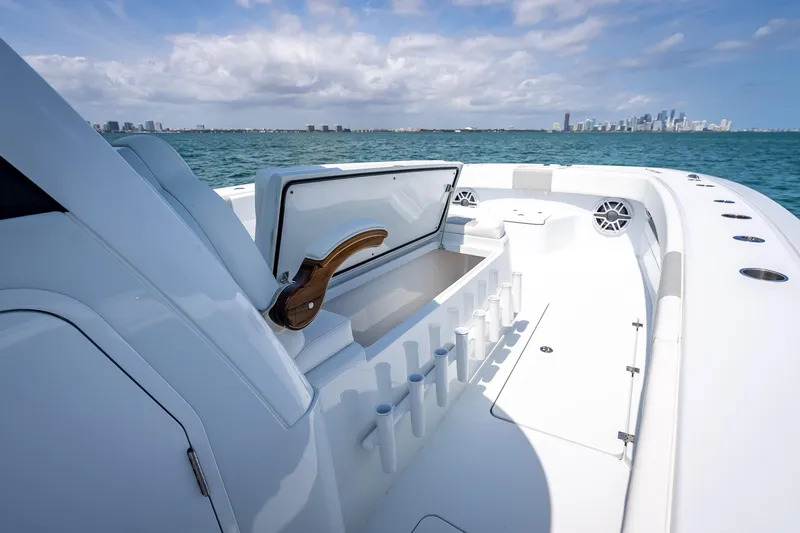 Slide: The Image of 2025 Freeman 43 boat interior with open storage, rod holders, and ocean view. - 75
