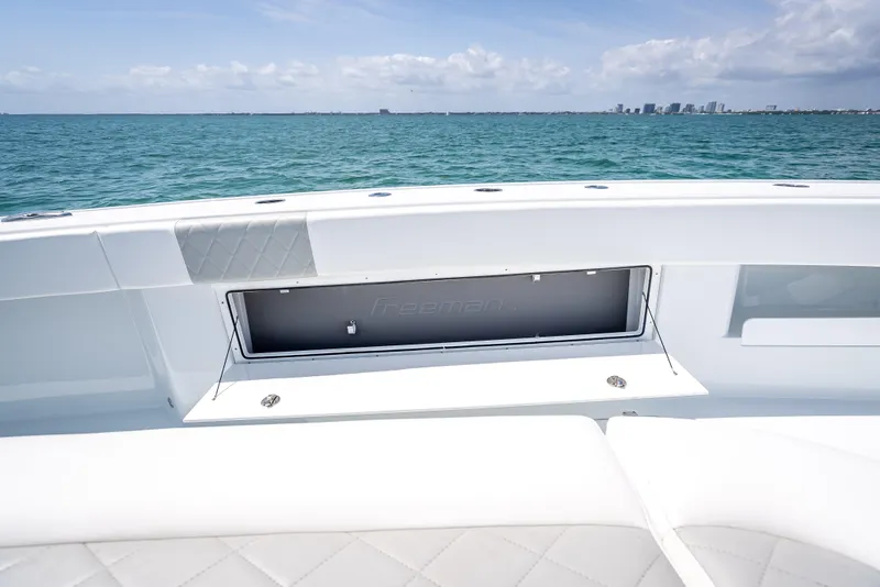 Slide: The Image of 2025 Freeman 43 boat interior with ocean view and city skyline in the background. - 78