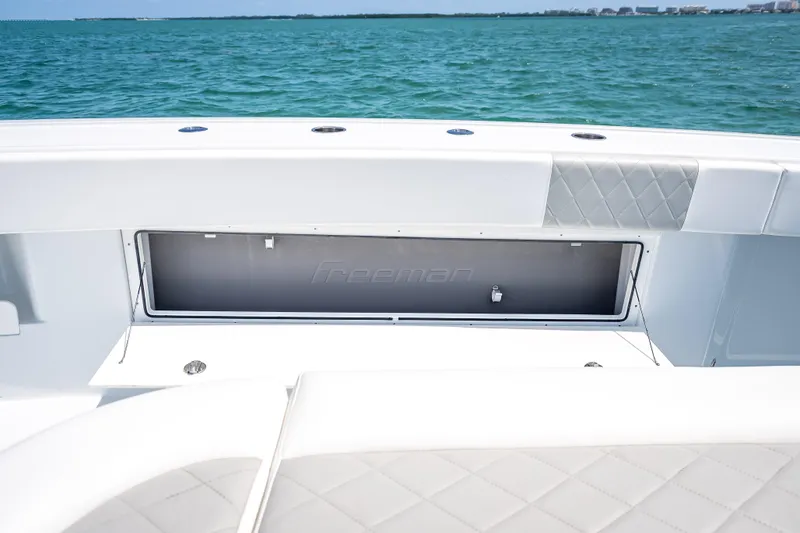 Slide: The Image of 2025 Freeman 43 boat interior with storage compartment, ocean view in background. - 79