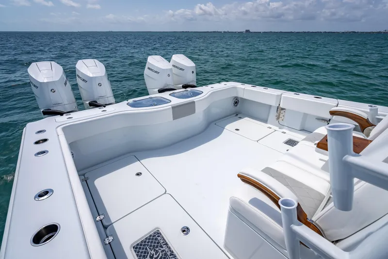 Slide: The Image of Luxury Freeman 43 boat deck with four Mercury engines, 2025 model, on open sea. - 98