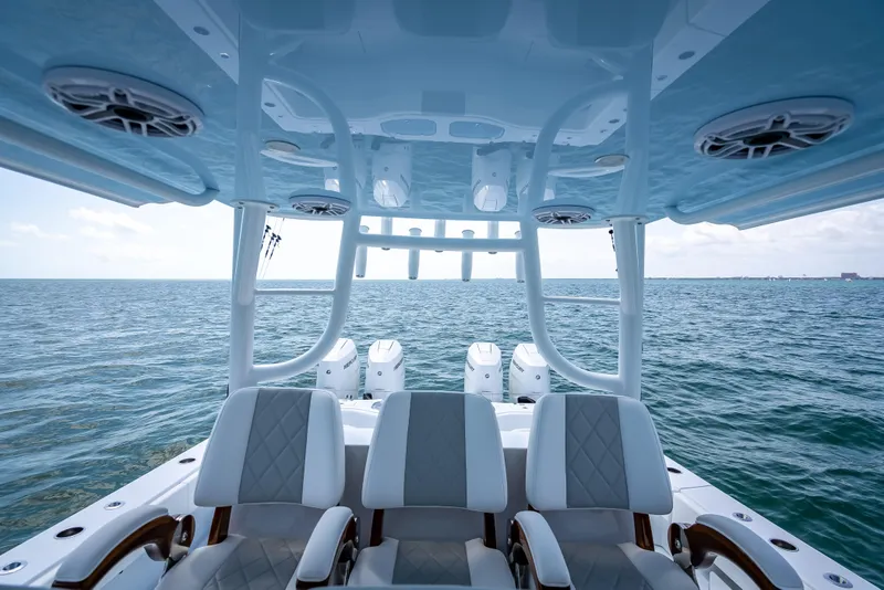 Slide: The Image of 2025 Freeman 43 boat interior with ocean view, featuring modern seating and equipment. - 99
