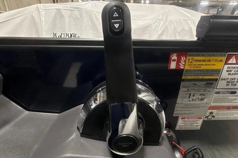 Slide: The Image of Throttle control of 2026 Bennington 23 SSBSF boat with capacity warning labels. - 15