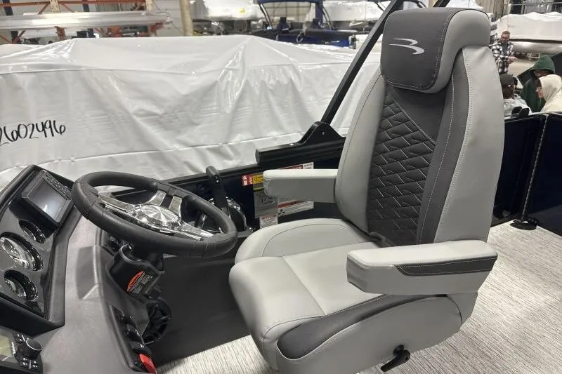 Slide: The Image of Captain's chair and helm of 2026 Bennington 23 SSBSF boat, featuring modern design. - 16