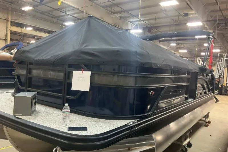 Slide: The Image of 2026 Bennington 23 SSBSF pontoon boat covered in a warehouse setting. - 20