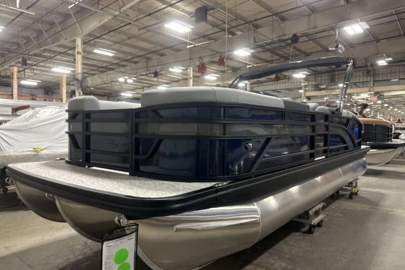 Slide: The Image of 2026 Bennington 23 SSBSF pontoon boat in a spacious indoor showroom. - 5