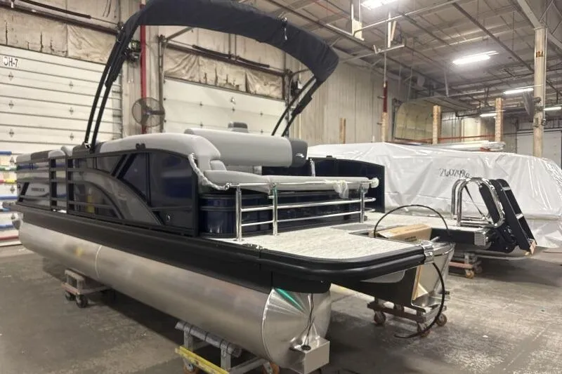 Slide: The Image of 2026 Bennington 23 SSBSF pontoon boat in a warehouse setting. - 6