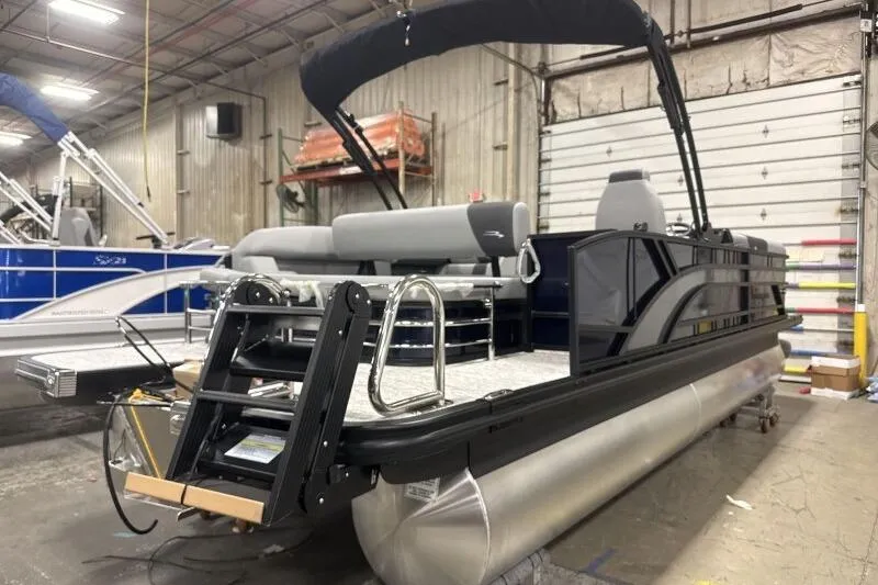 Slide: The Image of 2026 Bennington 23 SSBSF pontoon boat in a warehouse setting. - 8
