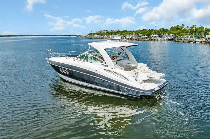 The Image of 2014 Cruiser 350 EXPRESS yacht cruising on a serene lake under a clear blue sky. - 1