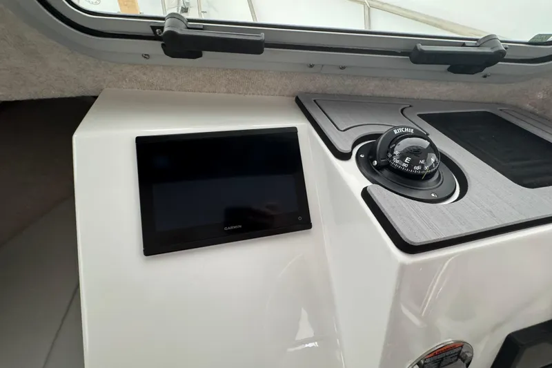 Slide: The Image of 2023 Parker 2120 Sport Cabin dashboard with Garmin display and Ritchie compass. - 10