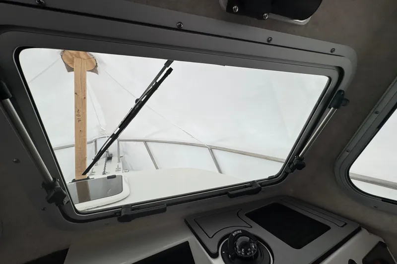 Slide: The Image of Interior view of 2023 Parker 2120 Sport Cabin boat through windshield. - 11