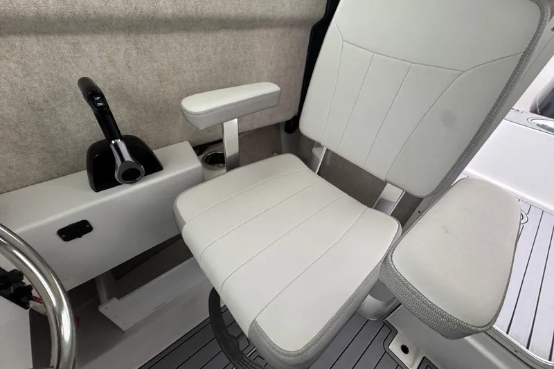 Slide: The Image of Captain's chair in 2023 Parker 2120 Sport Cabin boat, featuring sleek white upholstery. - 13