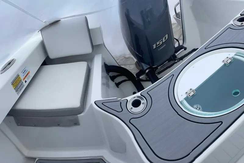 Slide: The Image of 2023 Parker 2120 Sport Cabin boat interior with Yamaha 150 engine and seating area. - 15