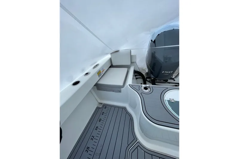 Slide: The Image of 2023 Parker 2120 Sport Cabin boat interior with seating and outboard motor. - 18