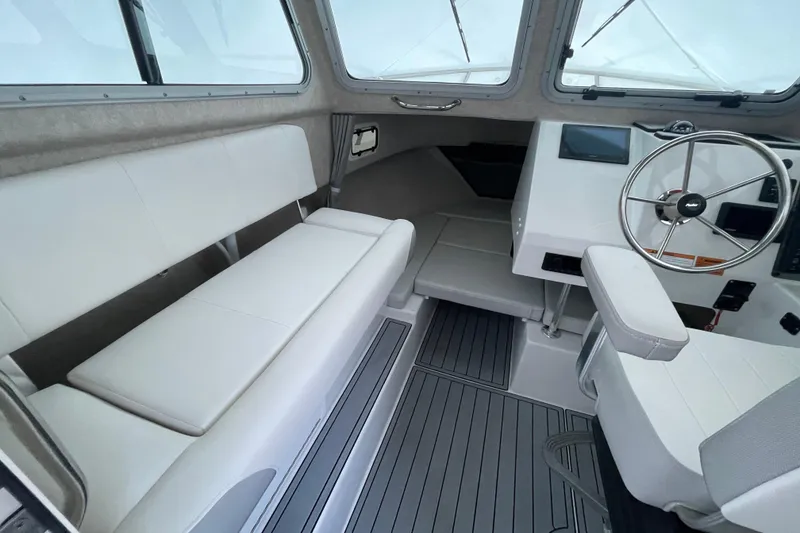 Slide: The Image of 2023 Parker 2120 Sport Cabin interior with seating and steering wheel. - 21