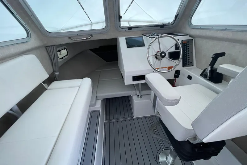 Slide: The Image of 2023 Parker 2120 Sport Cabin interior with steering wheel and seating. - 22