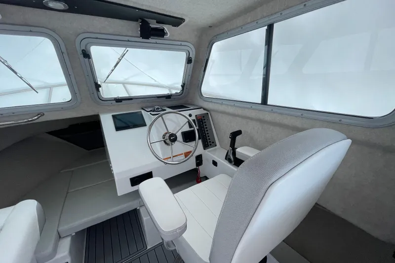 Slide: The Image of 2023 Parker 2120 Sport Cabin interior with steering wheel and control panel. - 24