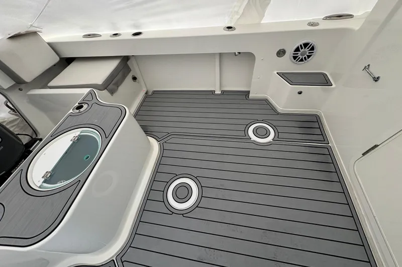 Slide: The Image of 2023 Parker 2120 Sport Cabin boat interior with sleek gray flooring and modern amenities. - 4