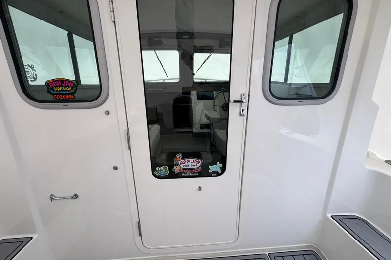 Slide: The Image of 2023 Parker 2120 Sport Cabin boat interior view through glass door. - 5