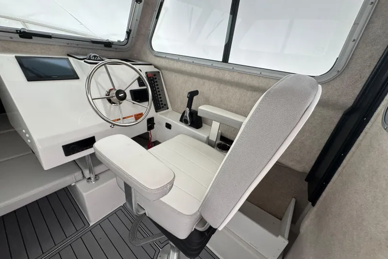 Slide: The Image of 2023 Parker 2120 Sport Cabin interior with steering wheel and captain's chair. - 7