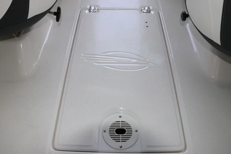 Slide: The Image of 2026 Chaparral 19 SSi OB boat interior with textured flooring and speaker grille. - 16