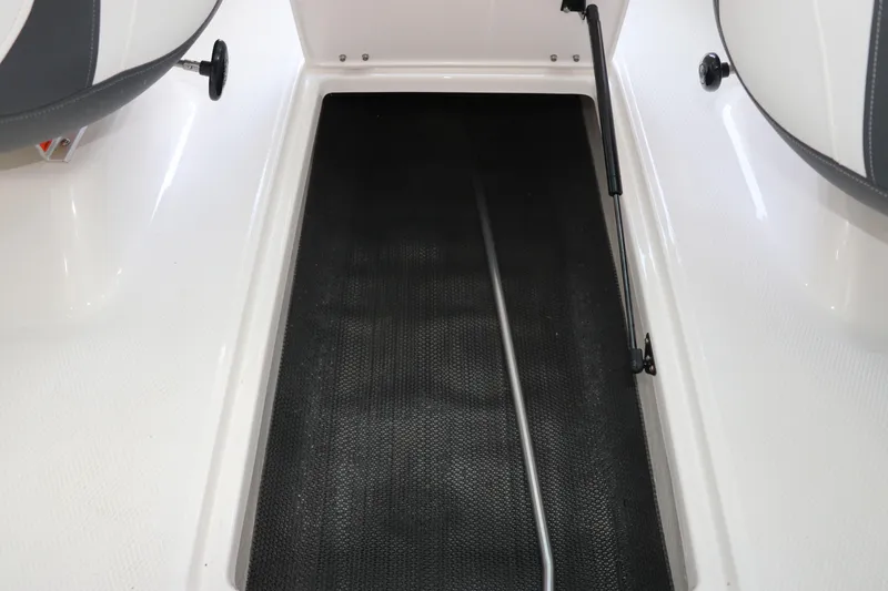 Slide: The Image of 2026 Chaparral 19 SSi OB boat storage compartment with hydraulic lift. - 17