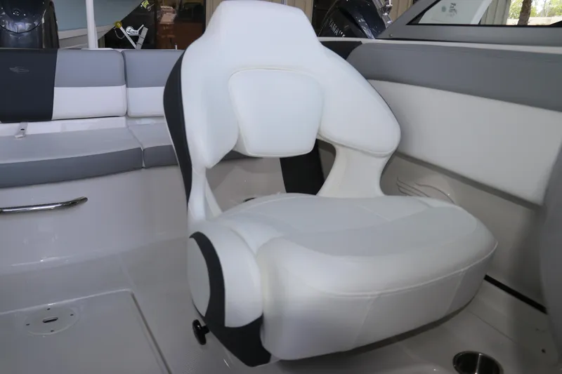 Slide: The Image of 2026 Chaparral 19 SSi OB boat interior with white captain's chair and seating area. - 19