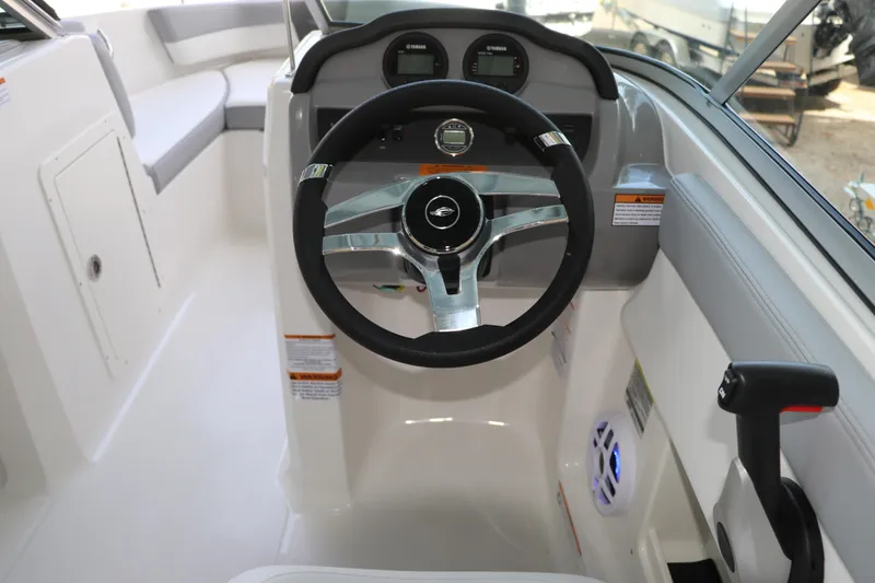 Slide: The Image of 2026 Chaparral 19 SSi OB boat cockpit with steering wheel and controls. - 24