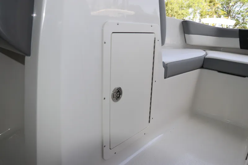 Slide: The Image of Interior view of 2026 Chaparral 19 SSi OB boat, featuring storage compartment and seating. - 28