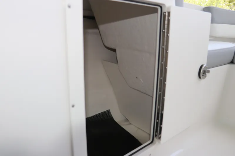 Slide: The Image of Open storage compartment on 2026 Chaparral 19 SSi OB boat. - 29