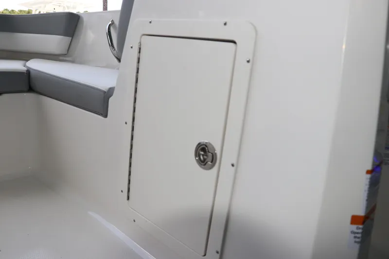 Slide: The Image of Interior view of 2026 Chaparral 19 SSi OB boat, featuring seating and storage compartment. - 30