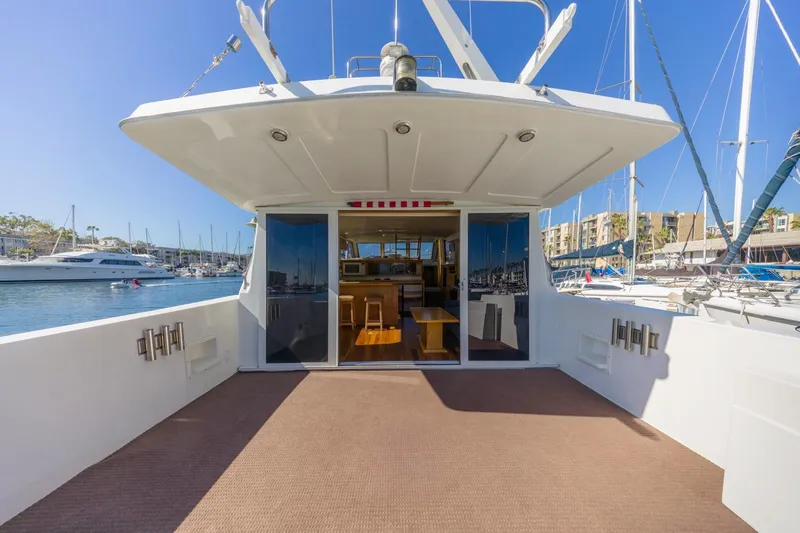 Slide: The Image of 1996 Navigator 5300 Classic yacht deck with marina view, featuring spacious seating area. - 11