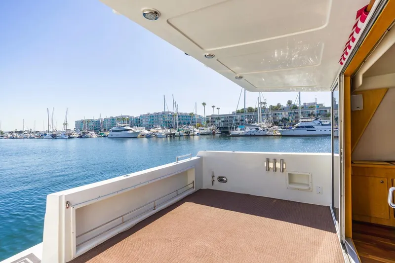 Slide: The Image of Spacious deck of 1996 Navigator 5300 Classic yacht overlooking marina with boats. - 13
