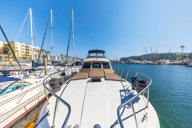 Slide: The Image of 1996 Navigator 5300 Classic yacht docked in a sunny marina, surrounded by sailboats. - 18