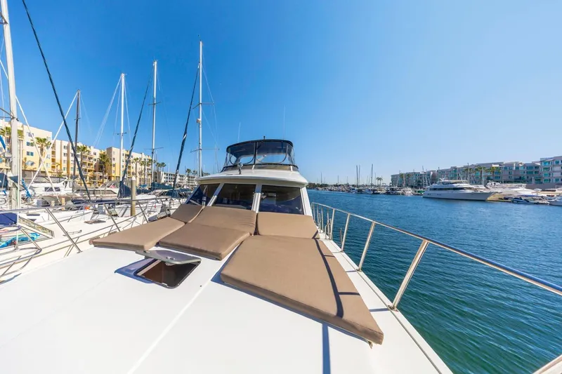 Slide: The Image of 1996 Navigator 5300 Classic yacht docked in a sunny marina, surrounded by sailboats. - 19