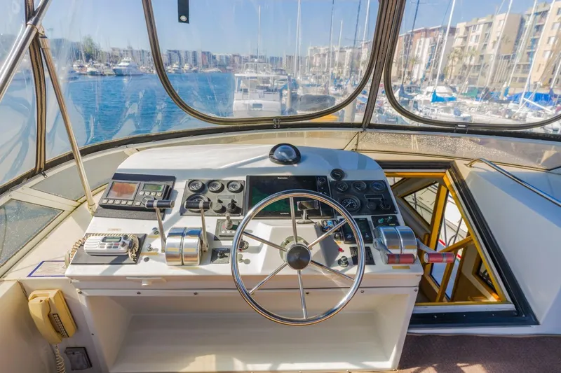 Slide: The Image of Cockpit of 1996 Navigator 5300 Classic yacht with marina view. - 23