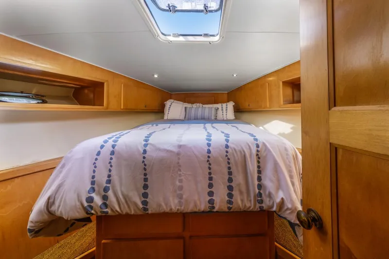 Slide: The Image of Cozy bedroom interior of 1996 Navigator 5300 Classic yacht with skylight and wooden cabinetry. - 36