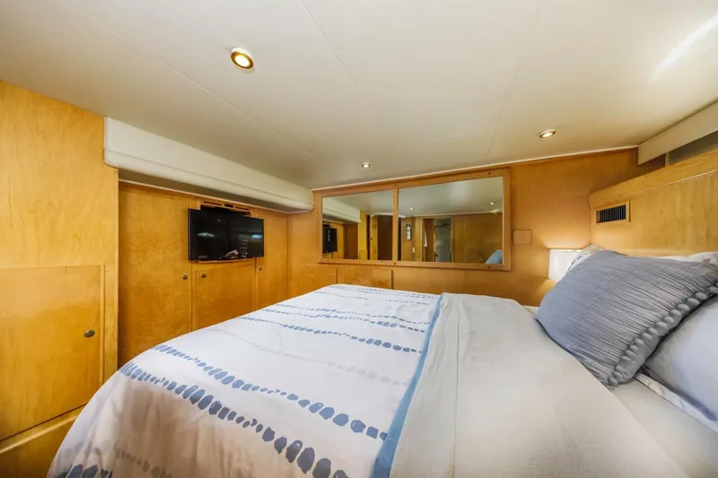 Slide: The Image of Luxurious bedroom interior of 1996 Navigator 5300 Classic yacht with wood paneling and cozy bedding. - 40