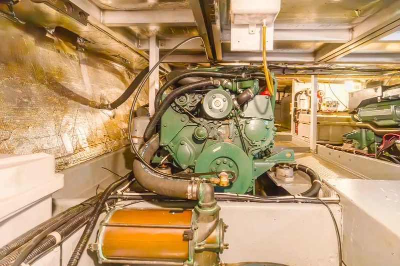 Slide: The Image of Engine room of a 1996 Navigator 5300 Classic yacht, showcasing mechanical components. - 58