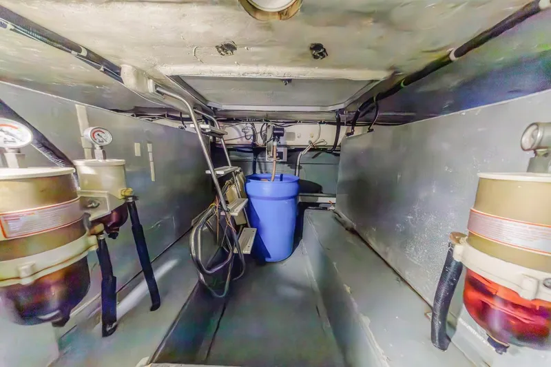 Slide: The Image of Engine room of 1996 Navigator 5300 Classic yacht with fuel filters and blue container. - 62