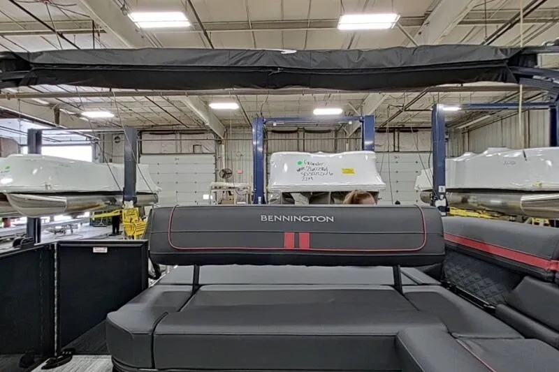 Slide: The Image of 2026 Bennington 23 SSBSF pontoon boat interior in a manufacturing facility. - 11