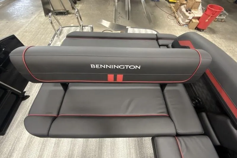 Slide: The Image of 2026 Bennington 23 SSBSF boat seat with gray and red upholstery in a workshop setting. - 17