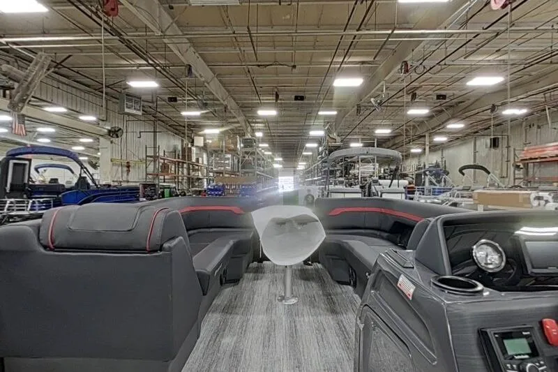 Slide: The Image of 2026 Bennington 23 SSBSF pontoon boat interior in a spacious factory setting. - 22