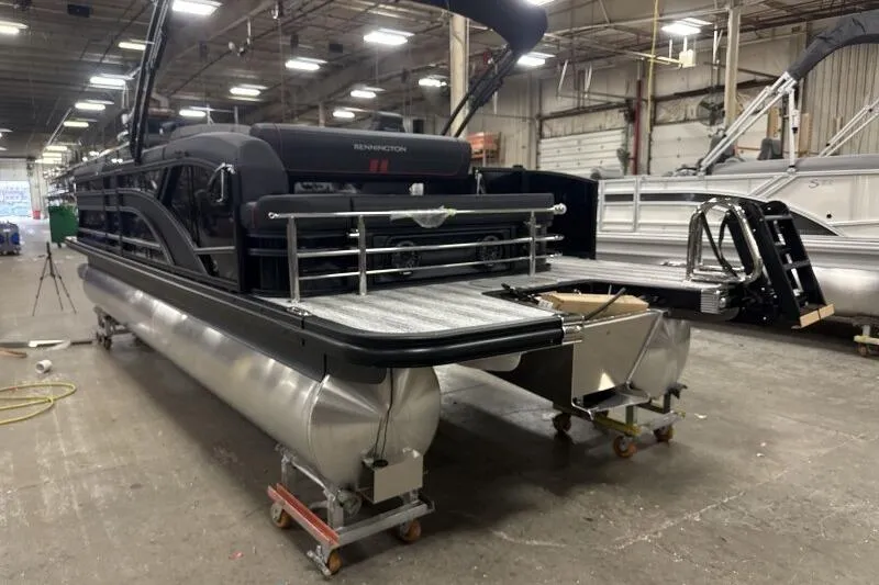 Slide: The Image of 2026 Bennington 23 SSBSF pontoon boat in a warehouse setting. - 8