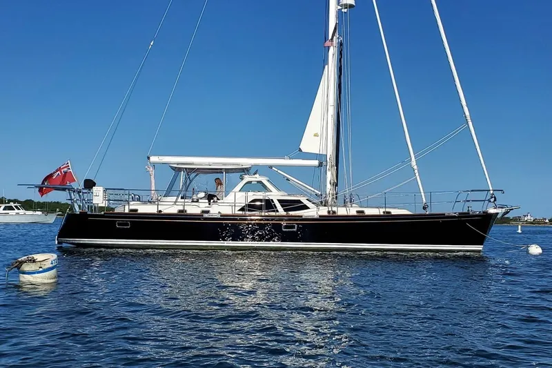 The Image of 2023 Bluewater 56 sailboat cruising on open sea under clear blue sky. - 0