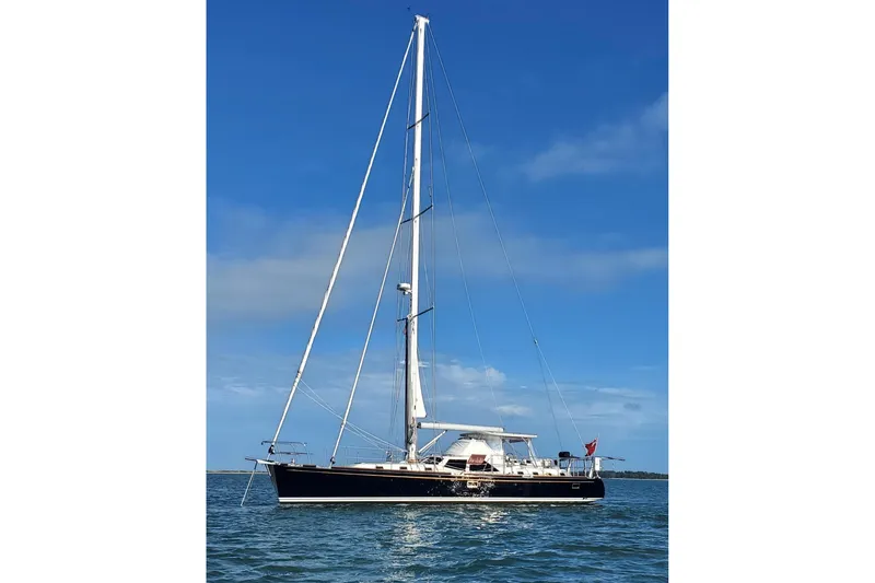 Slide: The Image of 2023 Bluewater 56 sailboat gliding on open sea with full sails. - 2